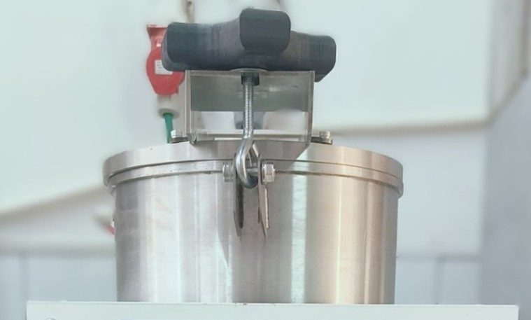 The top section of a HT machine for diamond color treatment, featuring a round stainless‑steel chamber with a clamped lid and a central locking mechanism.
